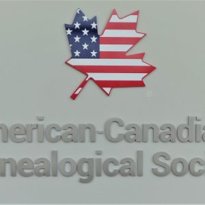 The American-Canadian Genealogical Society logo featuring a maple leaf with a US flag pattern.